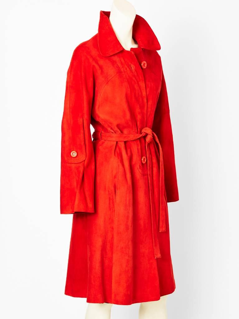Loewe, tomato red, belted suede coat, C. 1970's. Rounded collar, with seam detail on the front of the coat. Hidden pockets at the side font seams.
C. 1970's