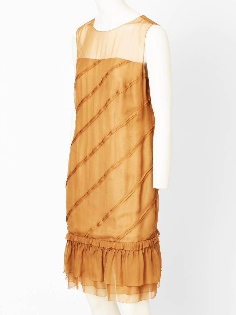 Chanel Couture,apricot tone, sleeveless, chiffon, chemise style, cocktail dress,
having diagonal, pleating detail and a gathered tiered hem.
