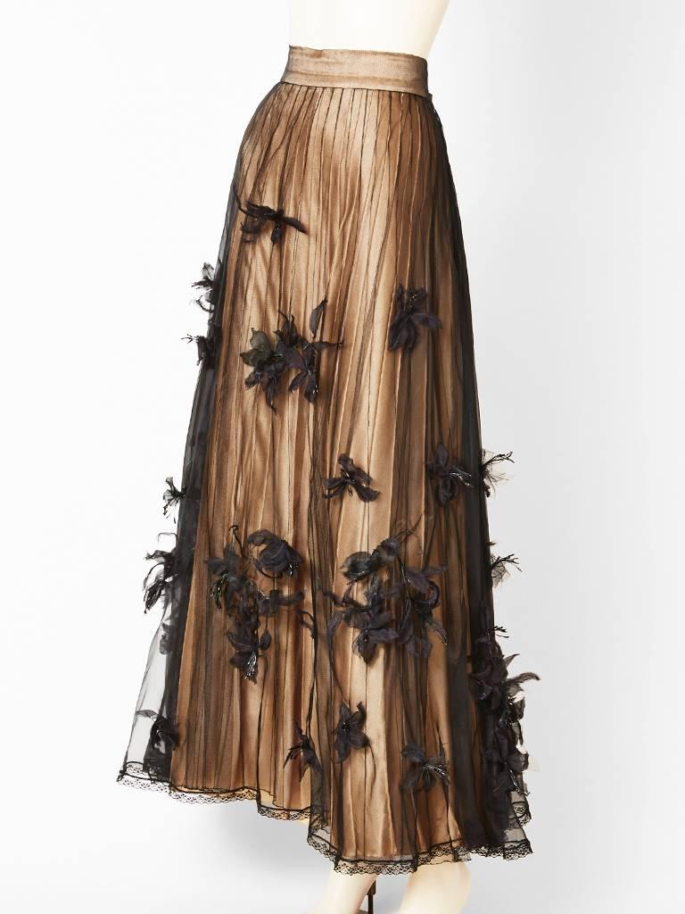 Chanel Couture, black, moussline de soie, layered evening skirt, embellished with appliqued  sculpted  flowers. Top layer is a sheer, moussline de soie,
over black silk tulle, over a nude pleated satin, over a  nude stiffened petticoat.
Top layer