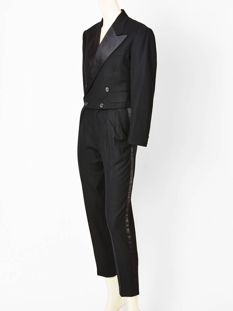 Ralph Lauren, women's wool tuxedo , having a double breasted, spencer jacket that ends at the waist with satin lapels. Trouser pant has pleats with side pockets having a narrow leg. 