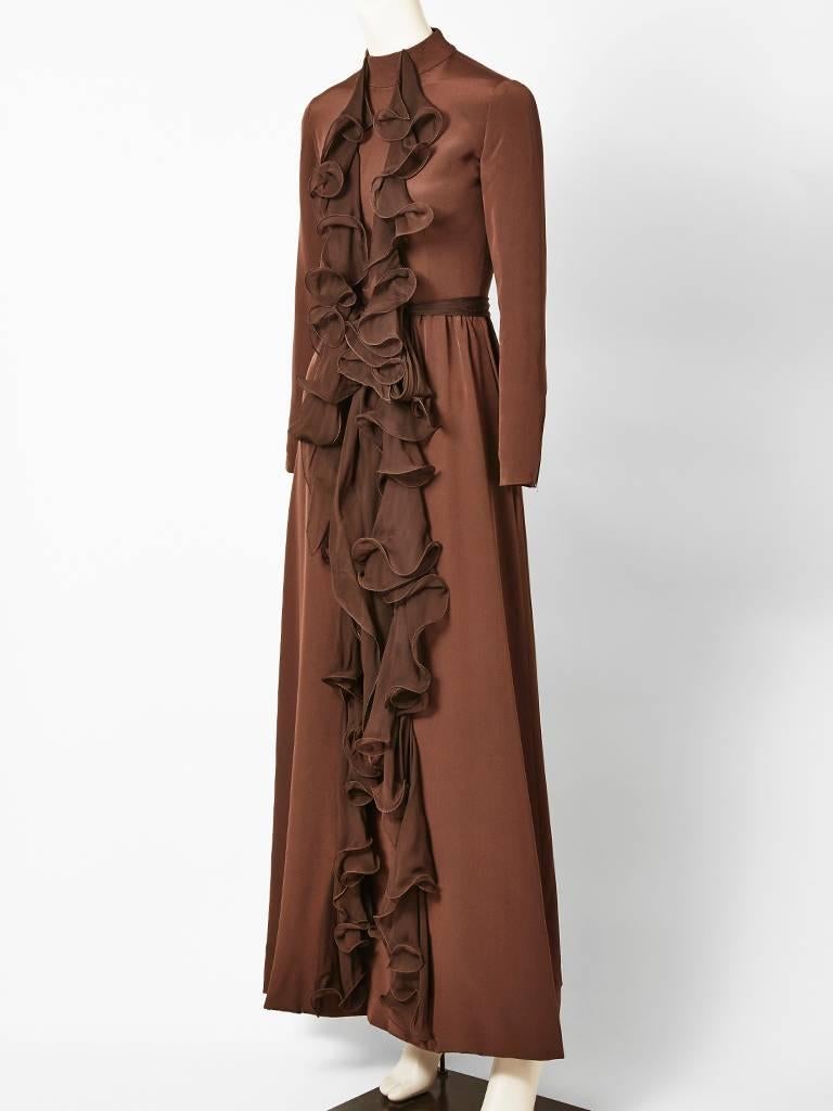 Ronald Amey, silk crepe, chocolate brown, long sleeve, gown with jeweled neckline, having vertical, chiffon, ruffle detail going down the center front.