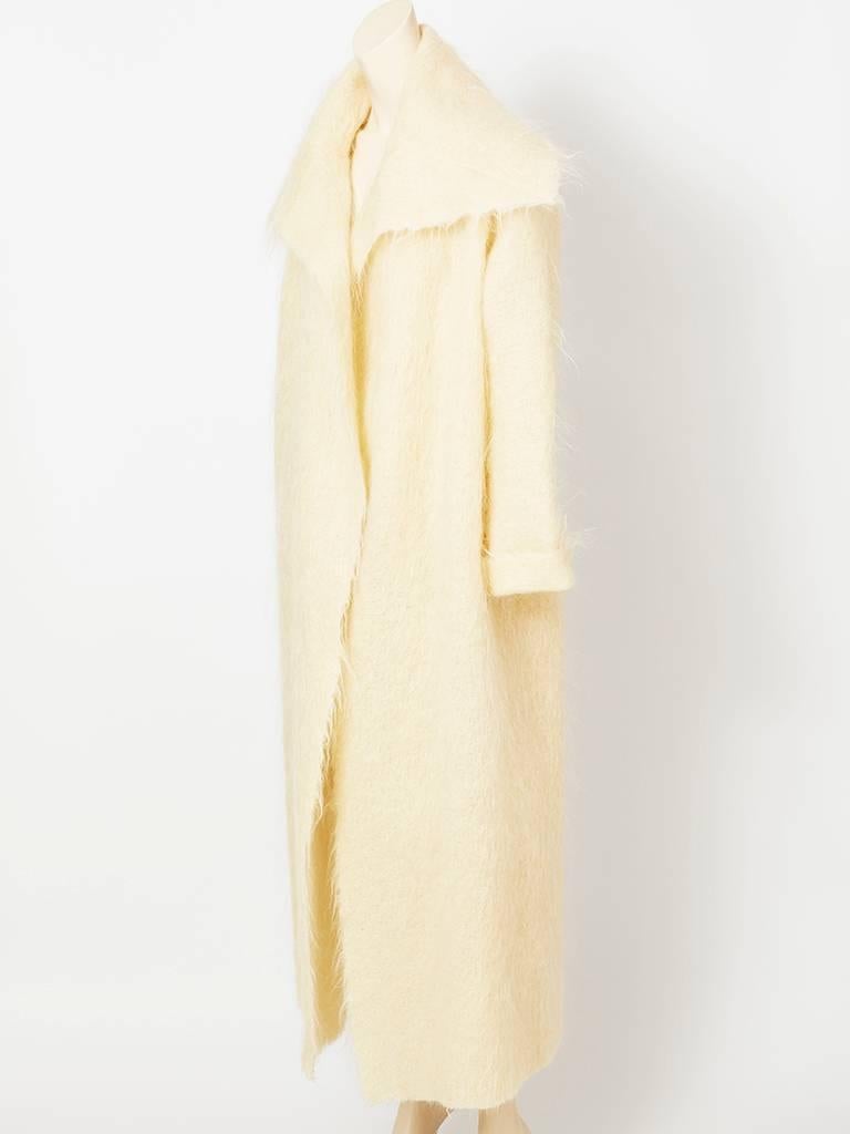 Shamask, Ivory, wool, mohair long , wrap coat, having no closures and kimono like sleeves. Generous collar, with frayed, mohair edges along collar, front and sleeves. Airy and lightweight.
