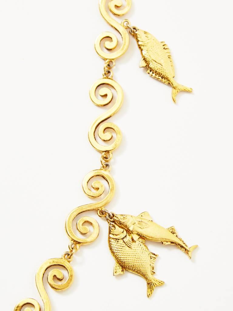 Yves Saint Laurent, gold tone necklace, embellished with fish, and shell motif 
charms. Chain consists of flat, 