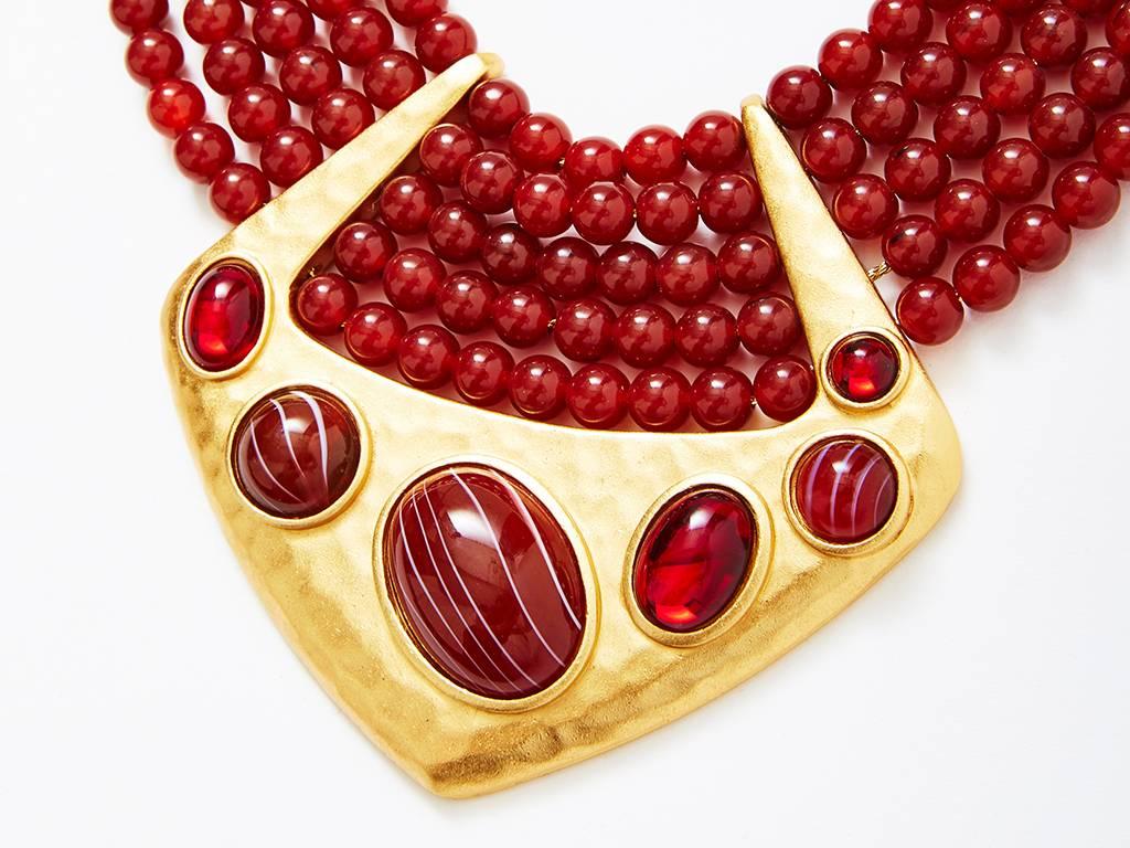 Yves Saint Laurent, multistrand, bib necklace with glass beads in a Carnelian color. Hammerd gold front detail embellished with 