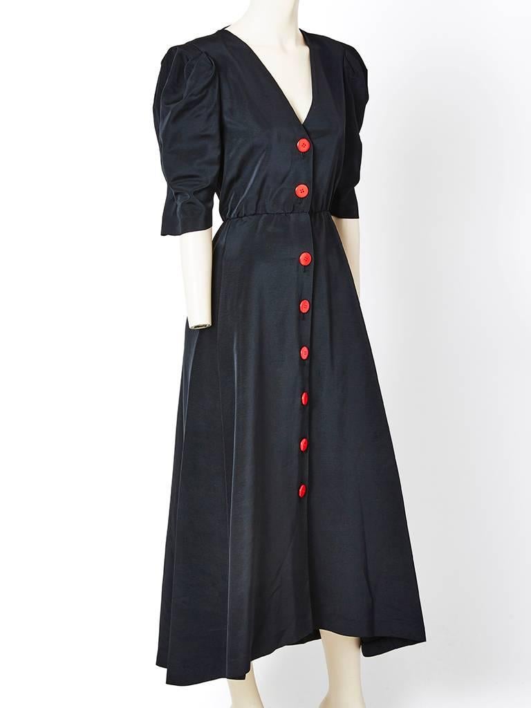Yves Saint Laurent, black moire 1940's inspired long dress, having a deep V neckline, puff sleeve at the shoulder, which ends just below the elbow. Waist line is slightly gathered. Red button closures going down the middle front of the dress.