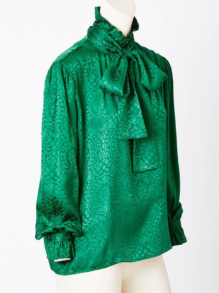 Yves Saint Laurent, bottle green, silk jacquard blouse having a ruffle at the neck and cuff with a tie at the neck.