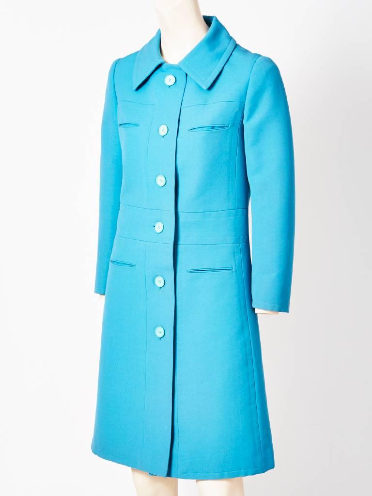 Nina Ricci, robins egg blue, wool coat, having a semi fitted body, with an A line.
Pointed collar, with slash pocket detail at the breast and hip. C. 1960's.