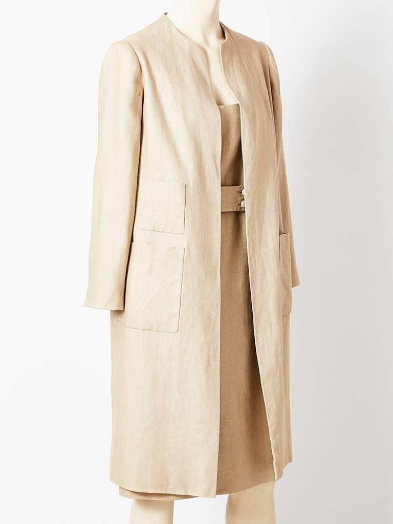 Norman Norell, natural color, linen coat and dress ensemble.  Dress is a simple sleeveless, belted sheath with a scoop neck and a deep open back.
Coat is collarless, having a straight silhouette with side pockets and no closures.
