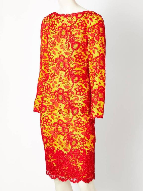 Galanos, lace and silk crepe,  long sleeve, cocktail dress . Red lace outer layer having a  floral ribbon embroidery detail over a yellow silk crepe, creating a dramatic color effect. Semi fitted, simple, silhouette, with a boat neckline in the