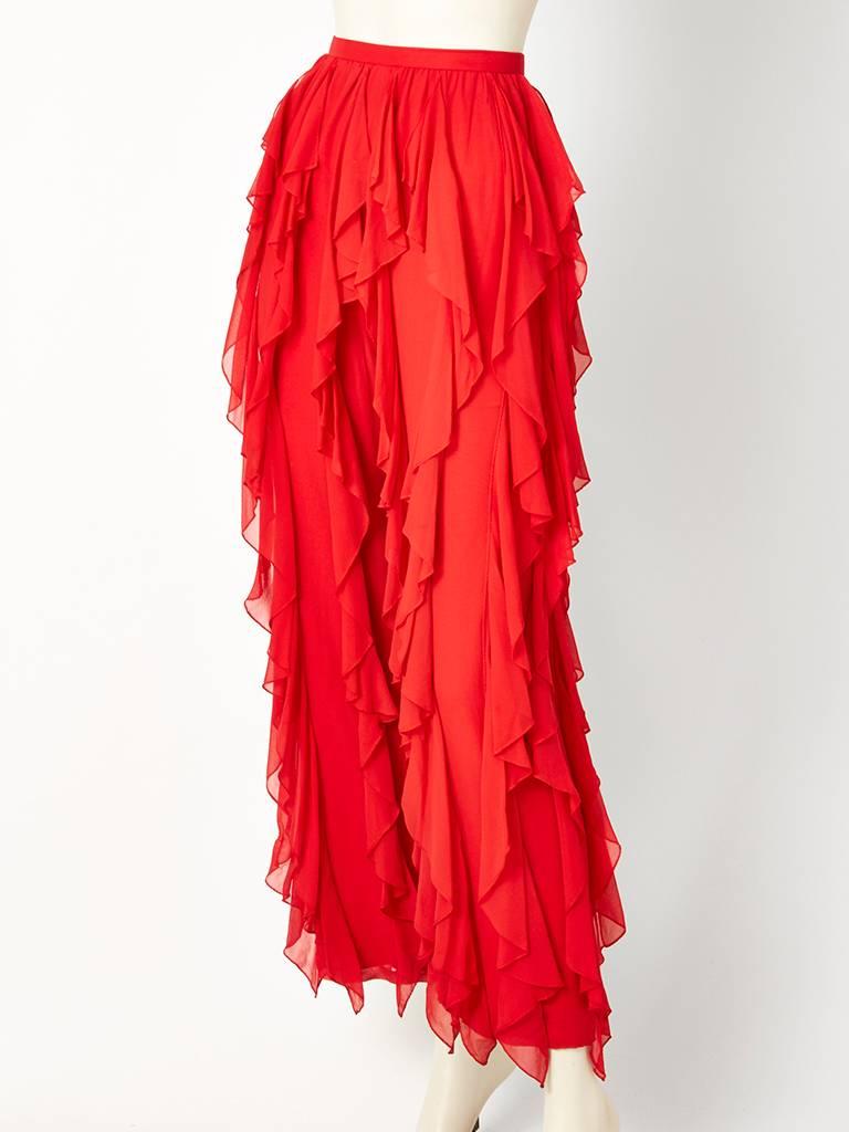 Red, silk chiffon wide leg pants, having vertically, placed, bias cut ruffles that extend down to the hem. These ruffles move as you walk.  Well made, missing designer label. Back zipper closure. C. 1970's.