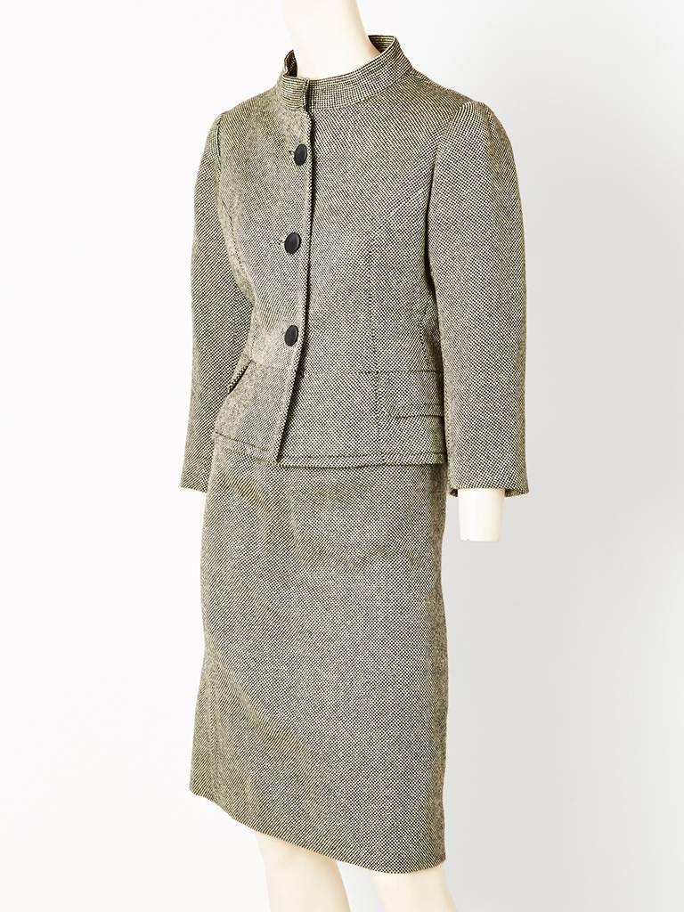 Elisa, black and white tweed suit , having a fitted bodice, mandarin collar,and a defined peplum. Skirt has a slight A line silhouette. This suit was made in the Balenciaga atelier in Madrid in the 1960's. Elisa was the name of Balenciaga's mother.