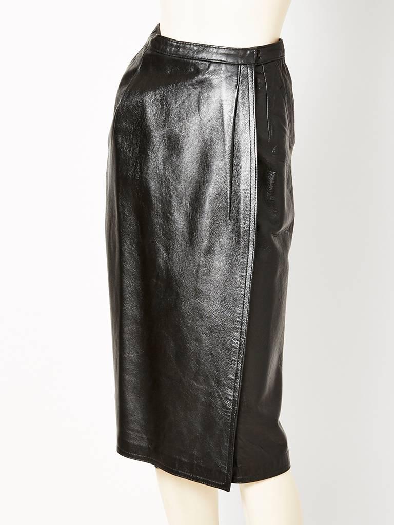 Yves Saint Laurent Leather wrap skirt C. 1970's having a slightly A line silhouette. ( label missing: this skirt was part of a suit which we decided to sell separately. ) Please note that the leather is supple but heavy.