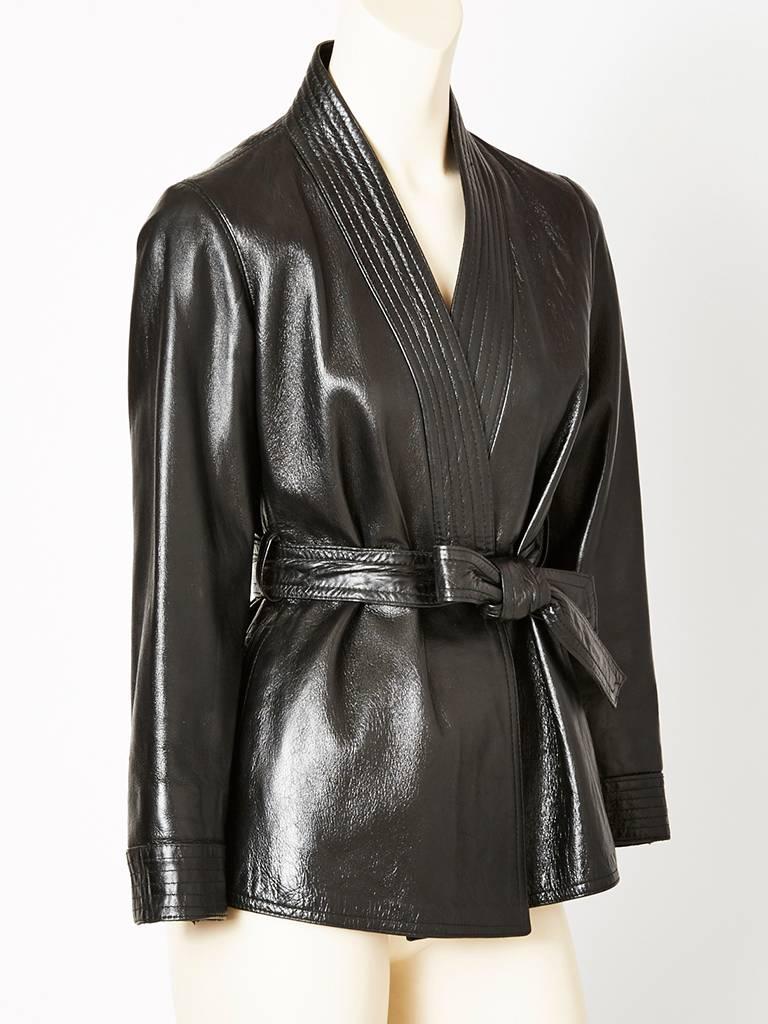 Yves Saint Laurent, black leather, belted, wrap jacket from the Chinese collection, late1970's.