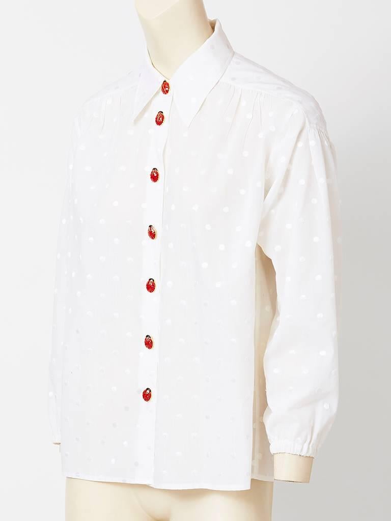 Yves Saint Laurent, dotted Swiss, cotton shirt , having a pointed shirt collar and enamel ladybug buttons. Sleeves are long and cuff at the wrist.