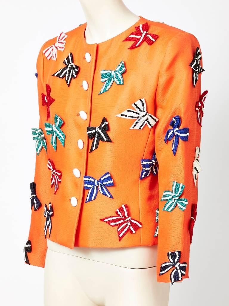 Yves Saint Laurent, orange silk bazar, semi fitted jacket, having no collar, front button closures, embellished with  multi colored sequined bows over the body and sleeves .
