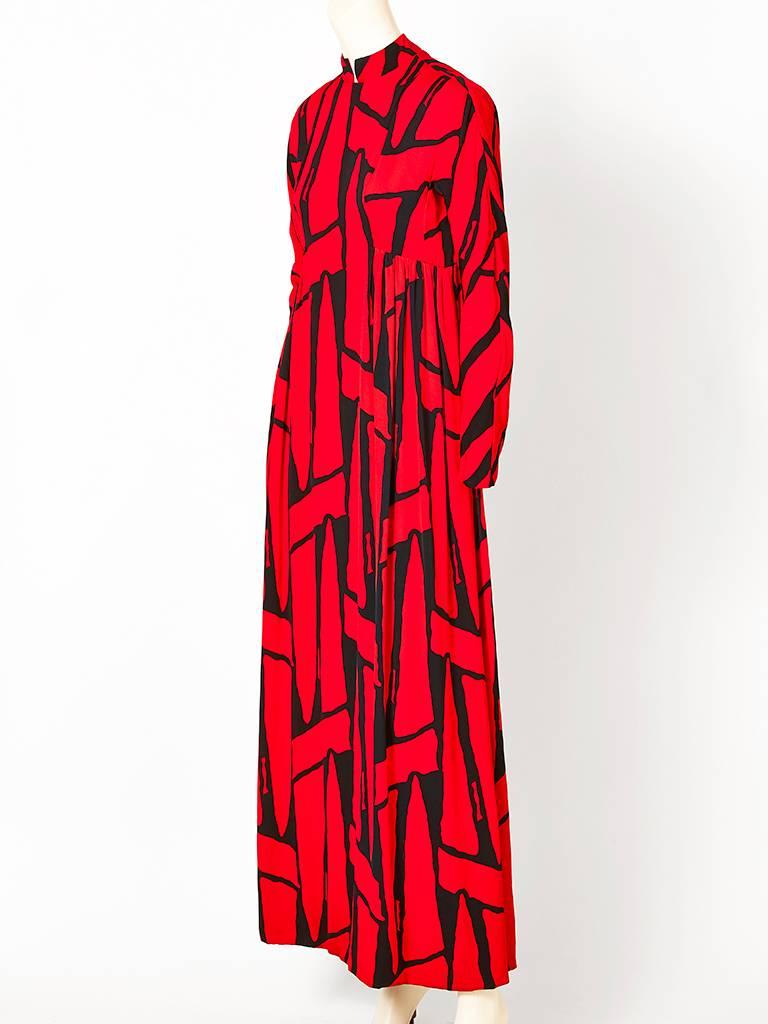 Geoffrey Beene, red and black graphic print, crepe, maxi dress, having a mandarin collar, long sleeves and an empire waist line. ( label is missing).
Authenticated by the original owner.