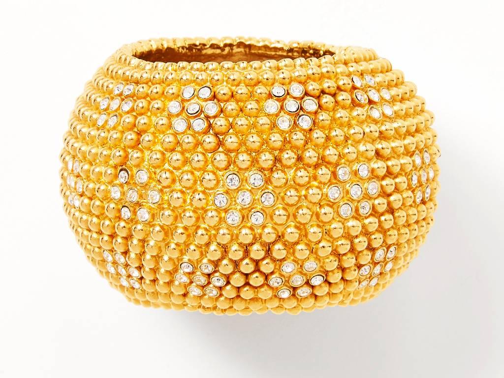 Yves Saint Laurent, gold tone, textured wide cuff, composed of tiny, raised, gold balls with clusters of rhinestones. 