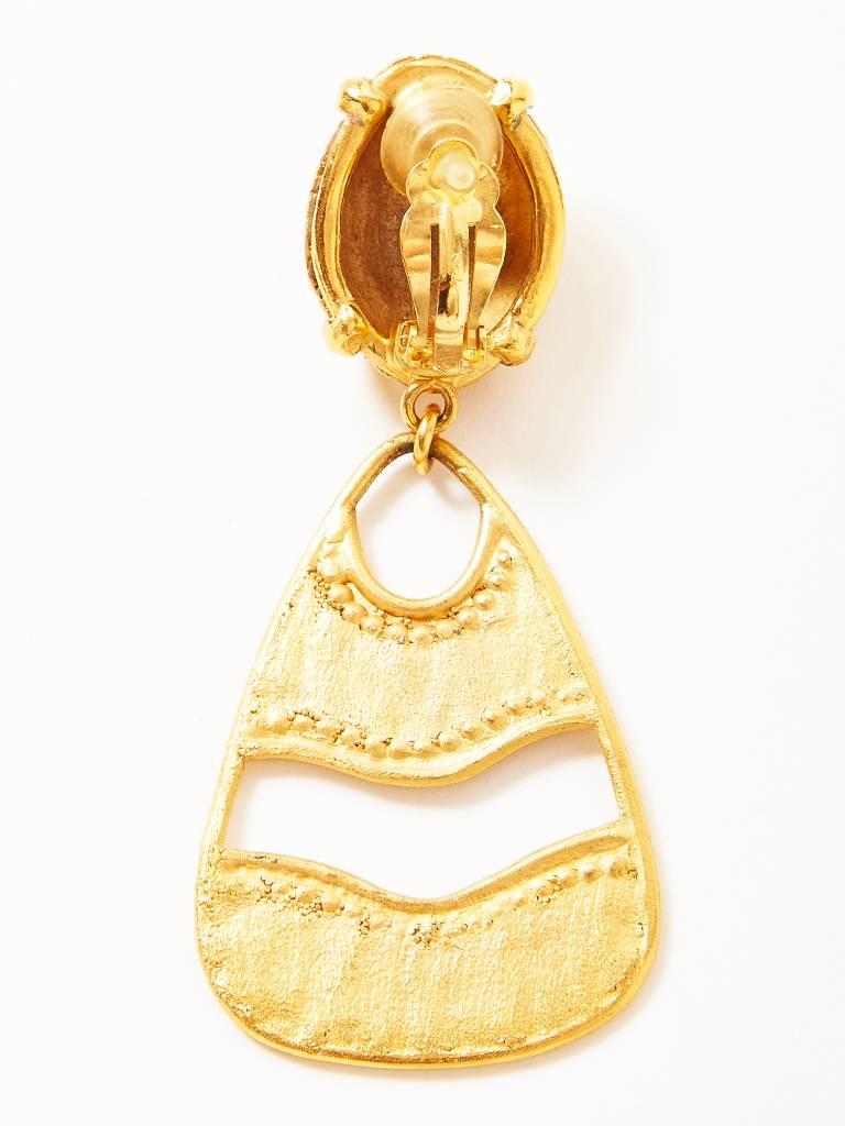 Yves Saint Laurent, gold tone, drop, clip on earrings, having a textured matte finish, with gold beaded detail.