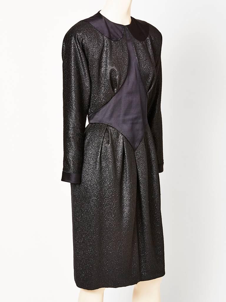 Geoffrey Beene, lurex cloché and silk charmeuse dress. The dress is mostly a black lurex cloché, with a matte, silk charmeuse, signature Beene inset at the bodice and  the signature Beene 