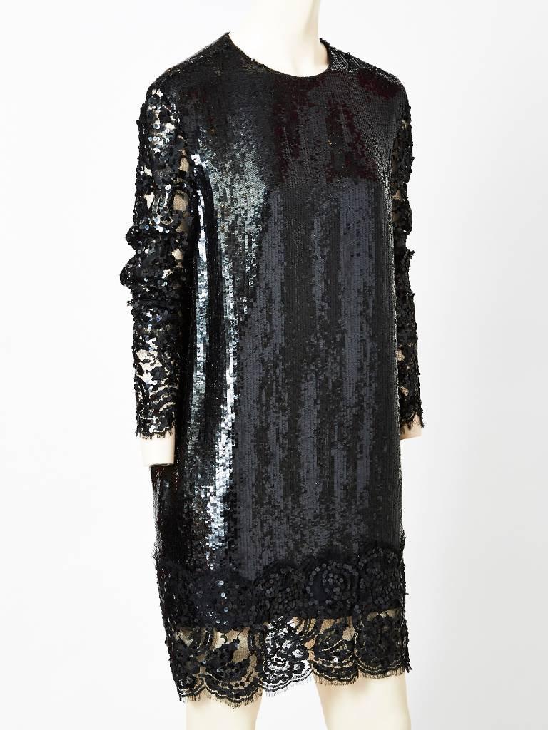 Geoffrey Beene, black sequined shift dress, having a jeweled neckline, long sheer,  lace, sleeves and lace hem detail.