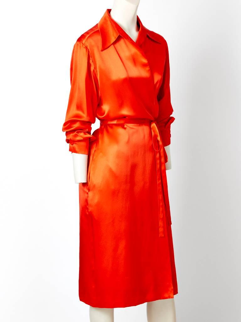 Yves Saint Laurent, rive gauche, silk charmeuse, wrap dress, having a pointed shirt like collar, long sleeves that cuff at the wrist and a side tie closure.