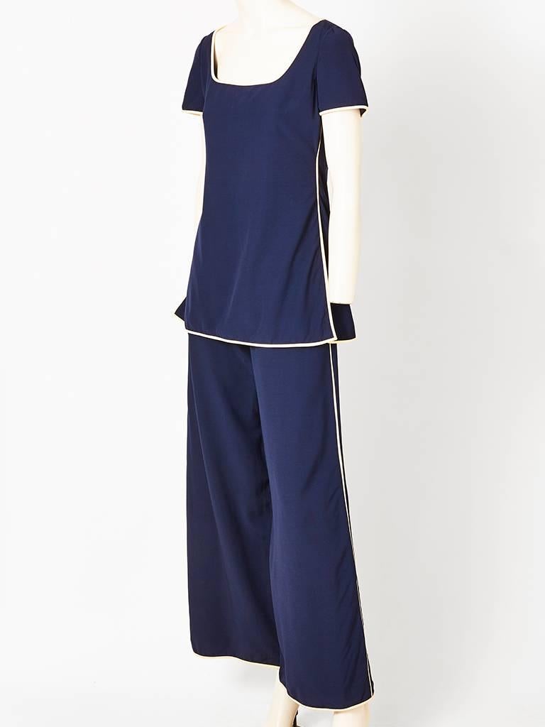 James Galanos, navy with ivory trim, nautical inspired pant and top ensemble. Tunic top, has a square neckline, having semi fitted bodice, which flares at the hip. There are side slits for ease. Pants are wide legged. Made of silk and wool