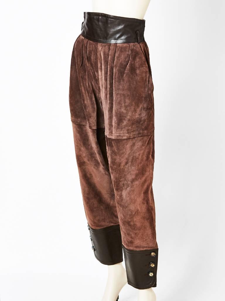 Yves Saint Laurent, rive gauche, high waisted  jodphur of suede and leather.
High waisted belt of pant is a black leather, the balance of the pants are a deep brown suede, having pleats at the waist. Pants taper at the calf to ankle where these is a