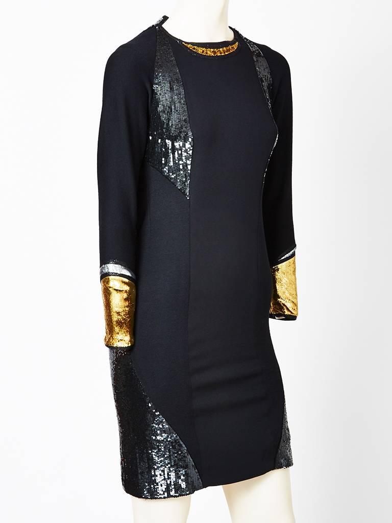 Geoffrey Beene fitted crepe de chine sheath having, an entirely sequined back and insets at the hem.
There are gold panne details at the wrists and neckline.
