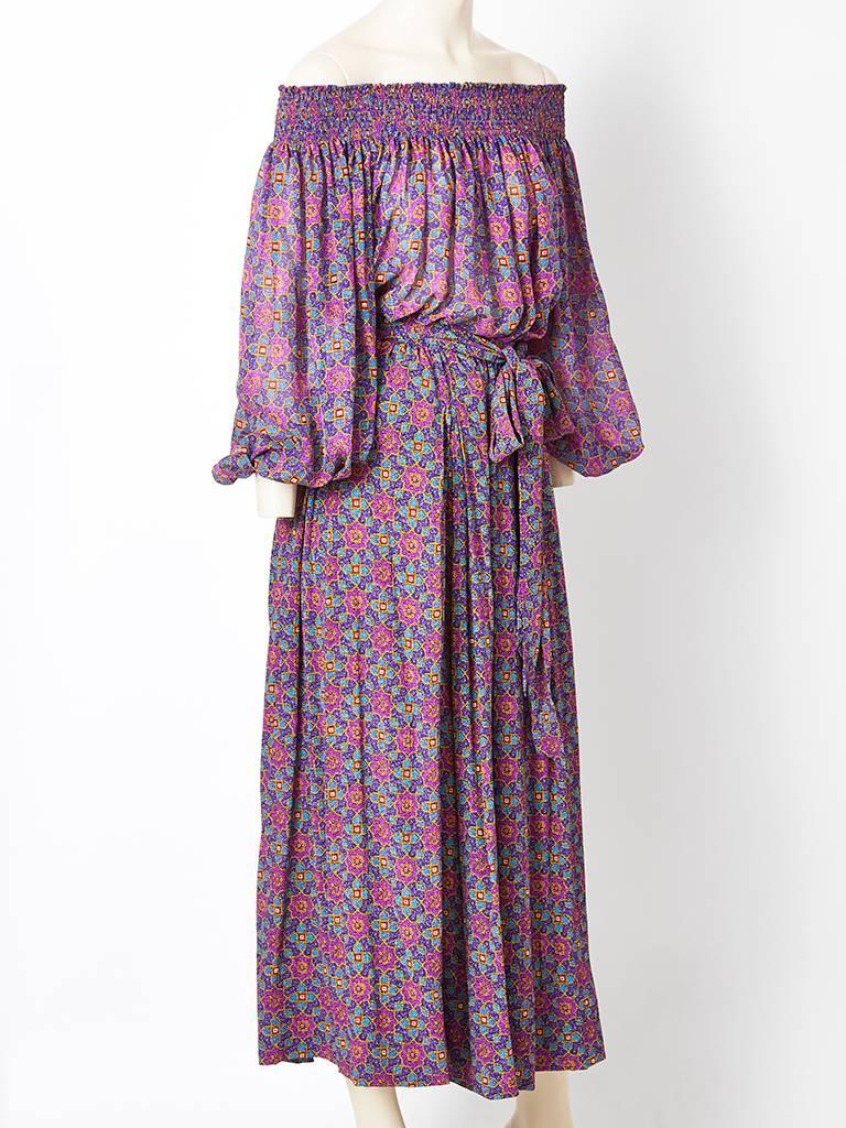 Yves Saint Laurent, Russian collection, patterned, silk and chiffon ensemble.
Lovely purple shade with a sheer chiffon, peasant style blouse having smocking at the neckline and wrists. Skirt is silk with gathering at the waist with a self belt 