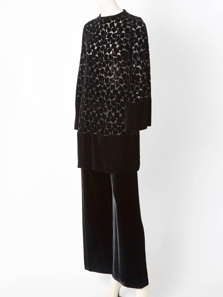 Yves Saint Laurent, black, cut velvet, long sleeved, tunic with a solid velvet, wide leg pant. Tunic is extra long, having a jeweled neckline, with a cut velvet body and a band of solid velvet at the hem and wrists. 
