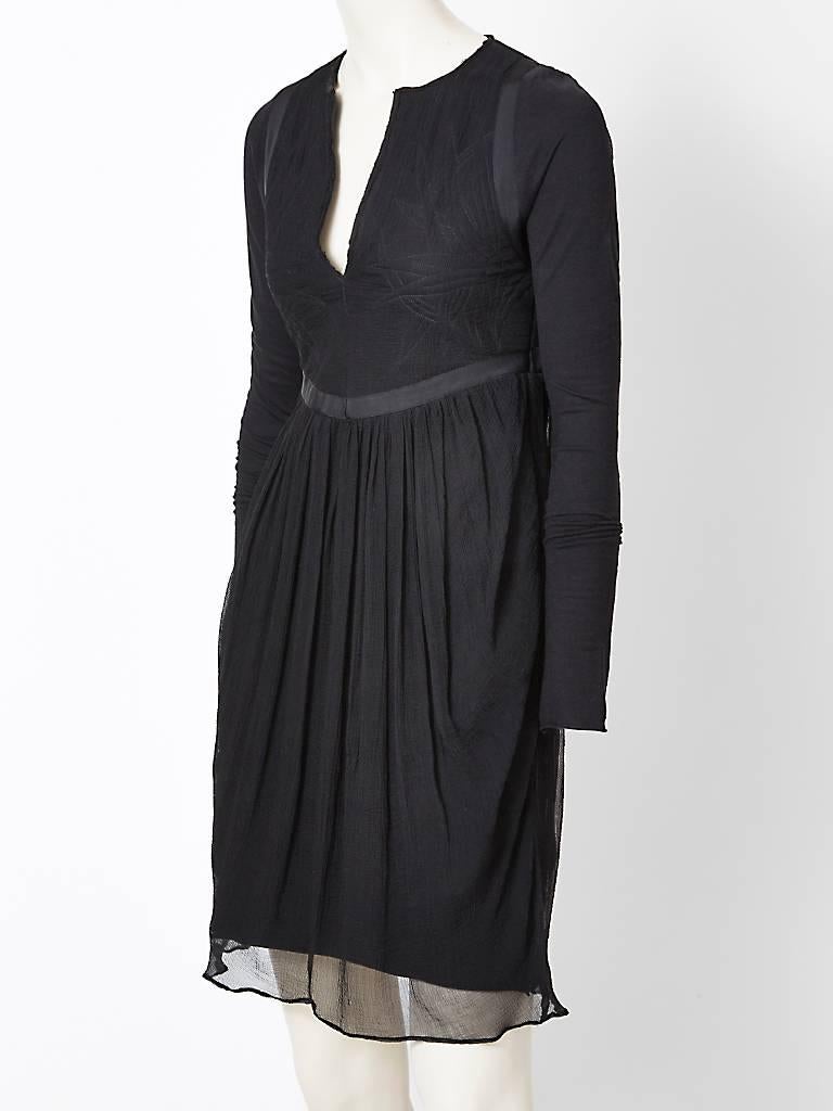 Nicolas Ghesquiere, for Balenciaga, black, dress having a slightly empire waist, and a layer of crinkled chiffon over a fine jersey knit. Sleeves are a jersey knit. Bodice has a deep V neckline and trapunto stitching detail with a gross grain ribbon