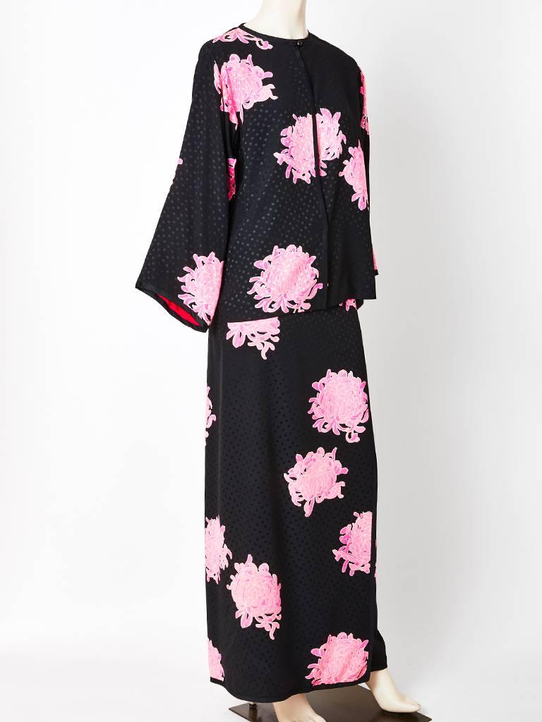 Yves Saint Laurent, couture, silk jacquard, 2 piece enemble, having a chrysanthemums pattern on a black background with fuchsia and pink tones.
Jacket/blouse has kimono-like sleeves. Top is collarless with center front closure having a silk ribbon