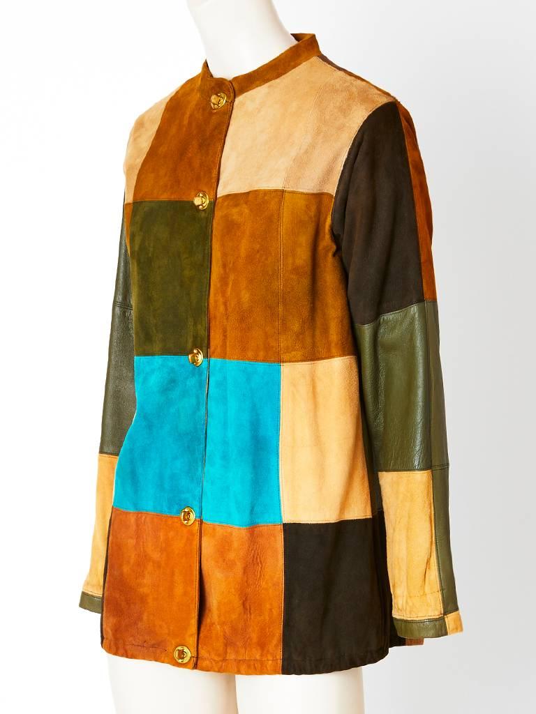 Bonnie Cashin, multi toned, patchwork, suede jacket, having no collar, long sleeves and signature brass Bonnie Cashin closures. C. 1970's. Patches of green leather inserted on the sleeves.