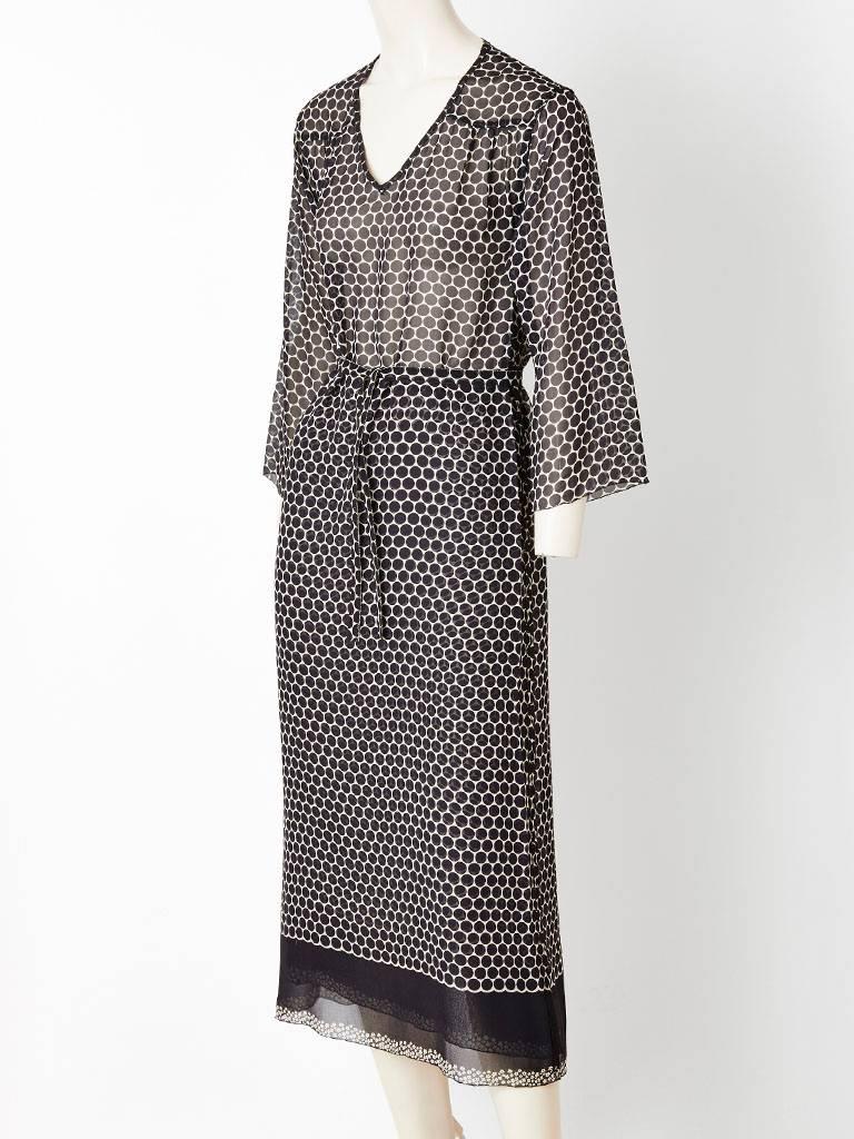 Sonia Rykiel black and white, dot pattern, long sleeve, Georgette shift dress. Simple straight silhouette with a v neckline having a skirt underpinning of the same pattern to create an opaque 
look. From the waist up, the dress is sheer. Can be worn