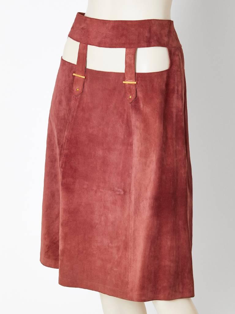 Gucci, mauve tone, suede a line skirt having rectangular cut out detail along the stomach, hips and back. Skirt sits slightly off the waist. C. 1970's