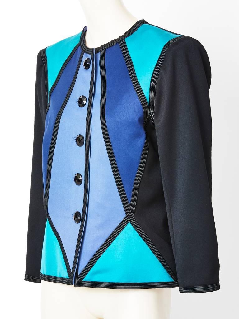 Yves Saint Laurent, Rive Gauche, duchess satin, color block, fitted dinner jacket in blue tones. Jacket is made of geometric satin fabric pieced together with black braid detail. There are black faceted glass buttons closures.  Back of jacket is