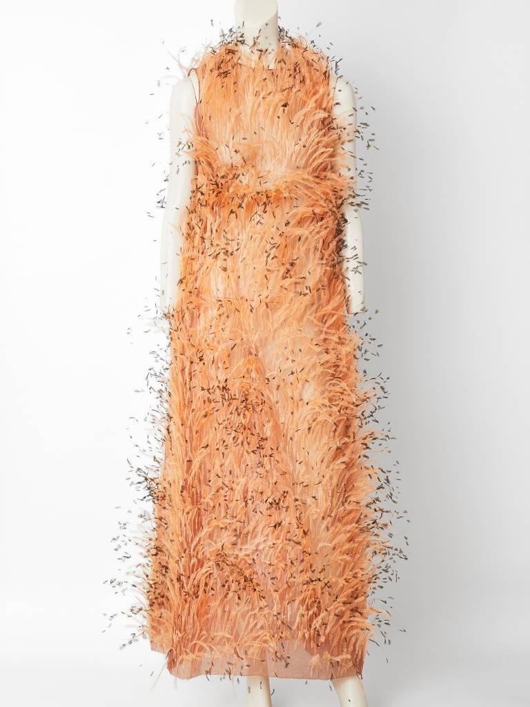 Balenciaga, nude tone, sleeveless A line, long gown, made of a silk organza encrusted with ostrich feathers of the same tone.  The feathers have brown tips. The slip to this dress is missing where one would see the Balenciaga label. The gown has a