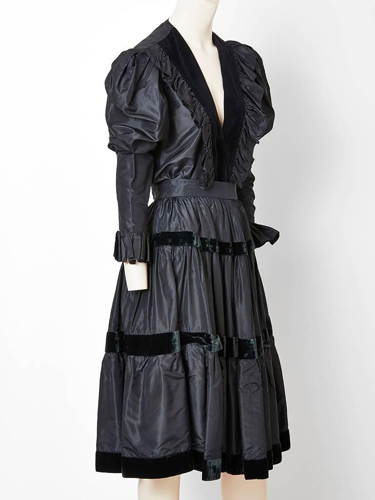 Yves Saint Laurent, Rive Gauche, black taffeta and velvet blouse and skirt ensemble.
Blouse is black taffeta with a deep V neck that is edged in velvet. There is a ruffle detail on either side of the velvet  starting at the shoulder and going down