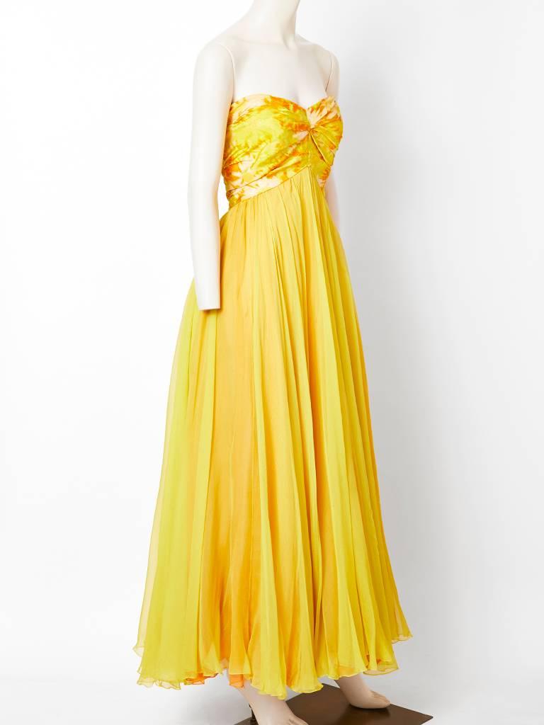 Sarmi, chiné taffeta and silk georgette strapless gown in lovely shades of lemon and melon. Bodice is a patterned chiné taffeta, slightly ruched at center front, with layers of bias cut silk, georgette starting under the bust and flowing down to the