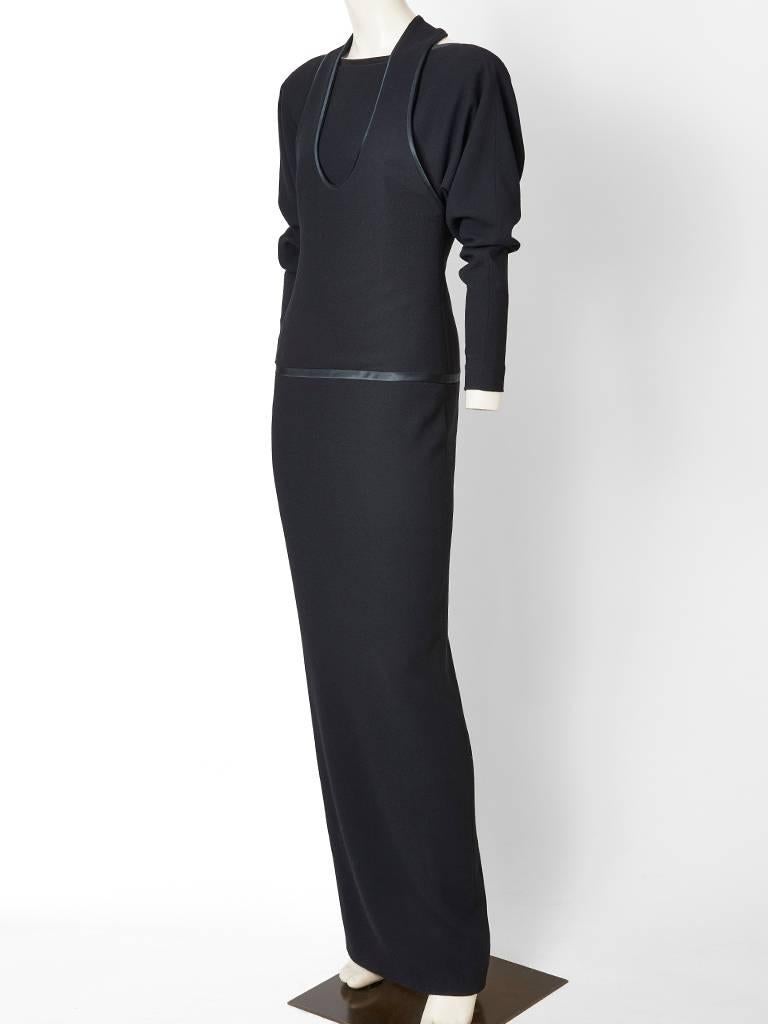 Galanos, wool crepe evening dress, with long sleeeves and a narrow silhouette.
Dress bodice and top has a sleeveless halter cut shoulder and a u neckline. The dress has an attached underpinned in the same wool crepe with long dolman shaped sleeves.