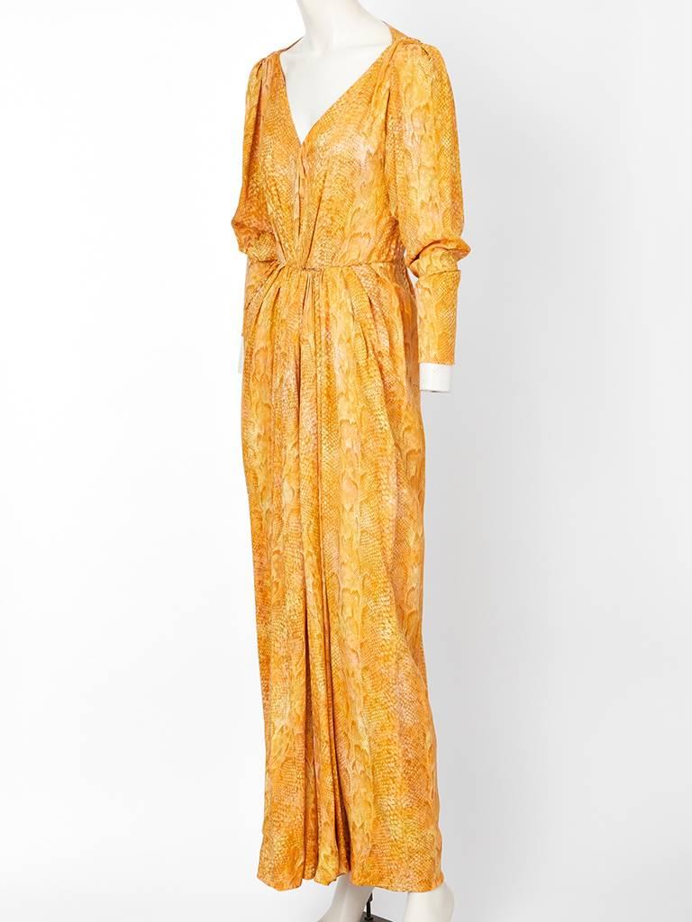 Yves Saint Laurent, saffron tone, silk jacquard reptile print  evening gown having dolman sleeves, a v neckline and center sorong like draping.
