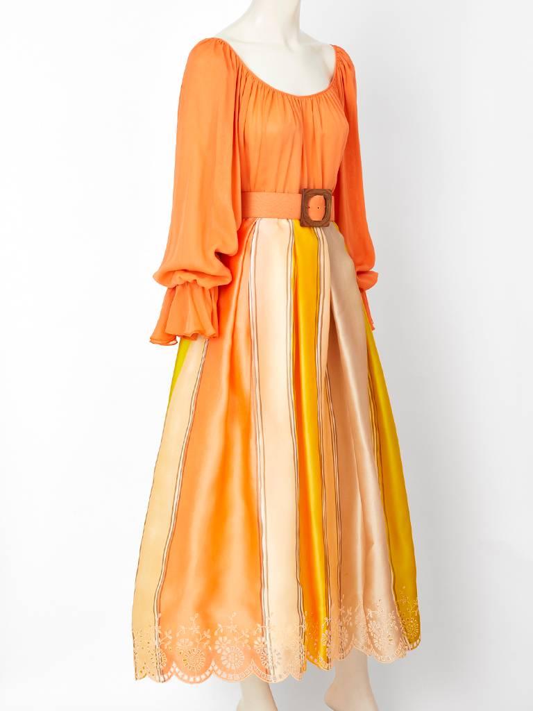 Oscar de la Renta, chiffon, and organza, gypsy ensemble in orange sherbet and lemon yellow colors.
Gypsy top is layered orange chiffon with a flounced cuff. Organza skirt is gathered at the waist, having a stripe pattern  with an embroidered eyelet