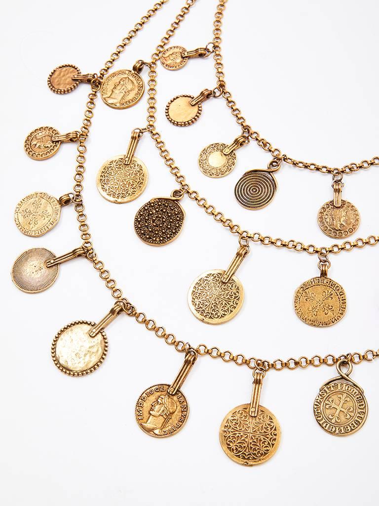 Yves Saint Laurent, bronze tone, triple strand necklace,  embellished with dangling faux antique coins. Each strand is a different length and when worn the necklace falls nicely on the chest.