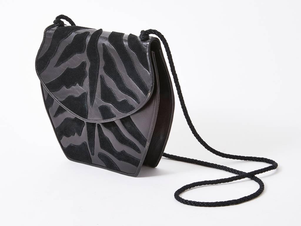 Yves Saint Laurent, Rive Gauche, back leather and suede reverse applique shoulder bag, having an animal print pattern and a braided cord strap.