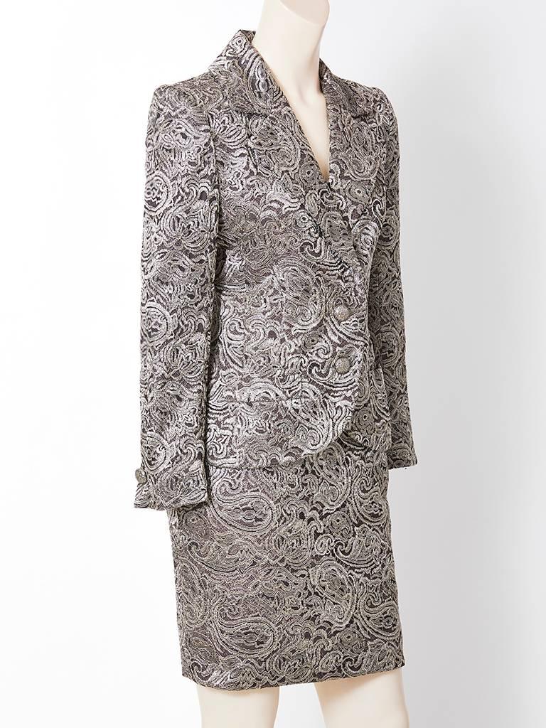 Jean-Louis Scherrer, dinner suit, made of a burnished gold metallic lace over a silk satin. Jacket is blazer style, having a fitted silhouette with notched lapels, two button closure and horizontal slit pockets. Skirt is straight with a hidden back