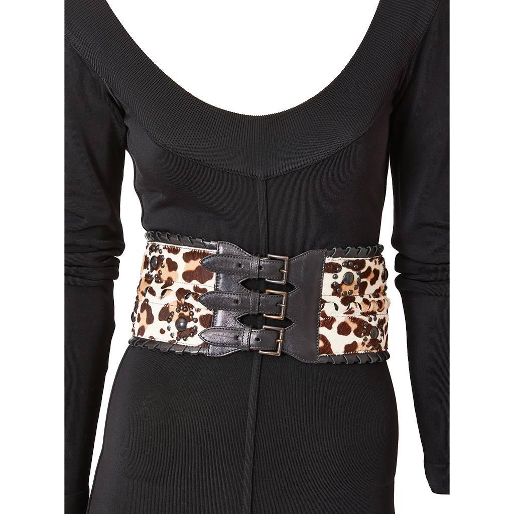 Azzedine Alaia, stenciled leopard, pattern on pony skin wide ( corset ) belt having studded brass embellishment and leather laced edging with triple buckle closure.