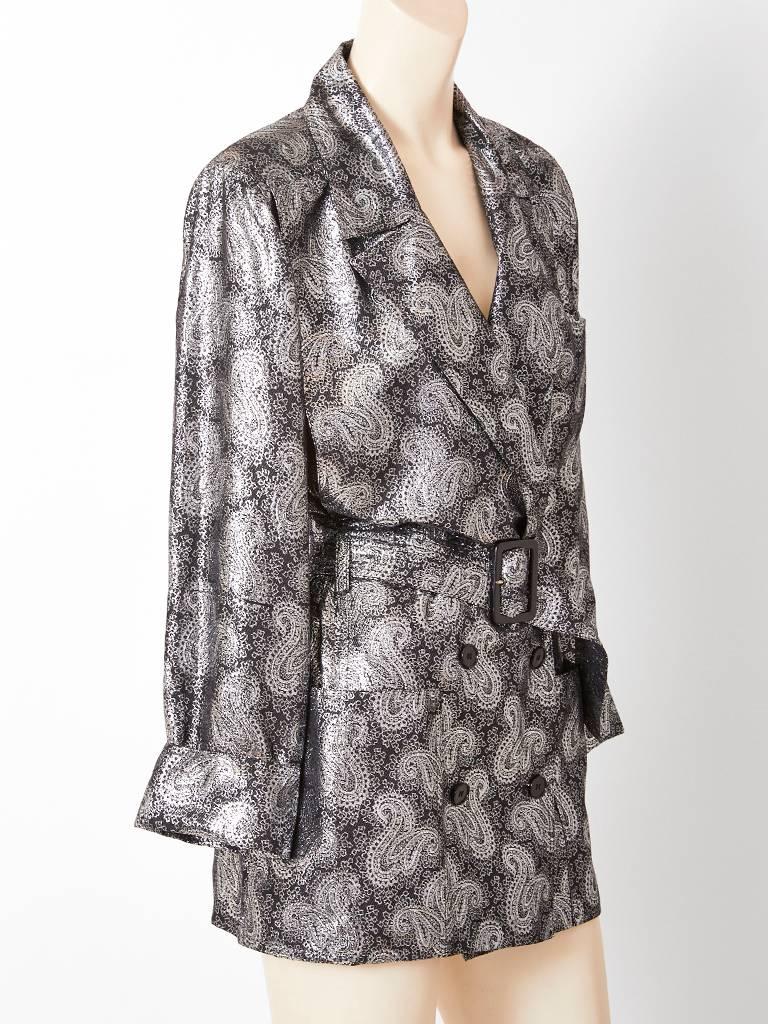 Jean Louis Scherrer, double breasted, silver lamé, silk, paisley pattern, belted evening jacket / trench, having deep side pockets and wide lapels.
