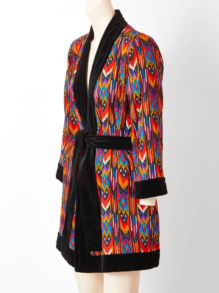 Yves Saint Laurent, Rive Gauche,  wool challis, multi toned, ikat pattern, wrap jacket having a black velvet edging and belt.
