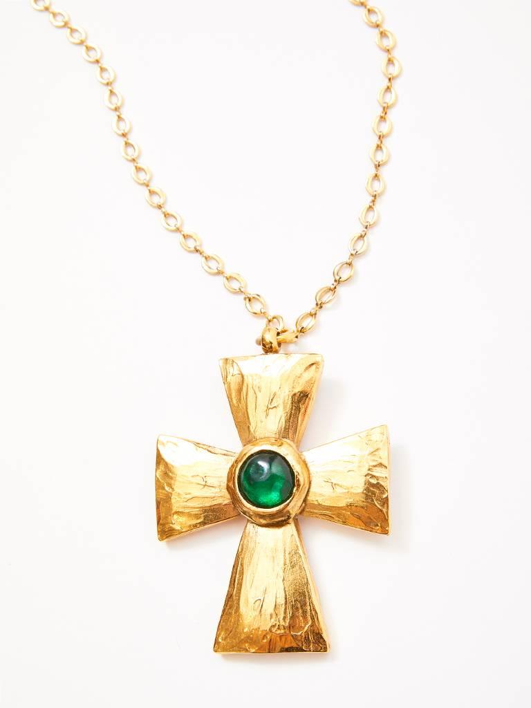 Yves Saint Laurent, Rive Gauche, textured, gold tone, Maltese cross having a faux emerald  cabochon stone on a long gold chain. 
 