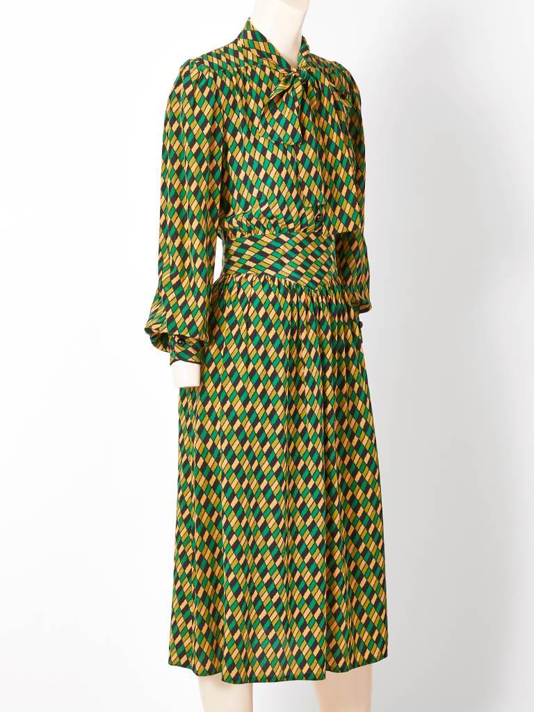 Givenchy Nouvelle Boutique, abstract diamond pattern, silk, long sleeve day dress having an attached self tie at the neck.
Hidden side pockets and a set in wide waistband . Front button and side zipper closures.
